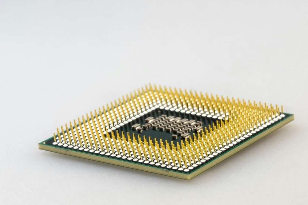 A detailed close-up of a CPU microchip showcasing its intricate gold pins and technology.